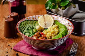 Useful Italian vegan food. Vegetarian bowl for breakfast of porridge couscous, avocado, cucumber, Brussels sprouts and vegetable stew. Keto diet. Background image.
