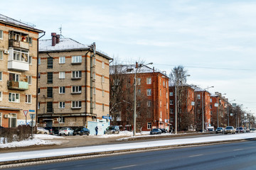 Fototapeta premium Before us is part of Chkalov Street of the city of Perm. Five-story houses of gray and red brick.