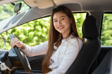 Fototapeta na wymiar Beautiful attractive young woman smile in casual sitting in car,Diving car with confident and happiness feeling,Happy transport concept