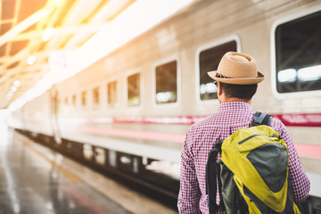 Young man standing at train station