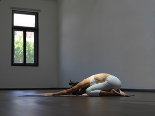 Asian chinese single woman in white practising Yoga