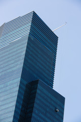 blue color glass skyscraper facade. business life theme for background