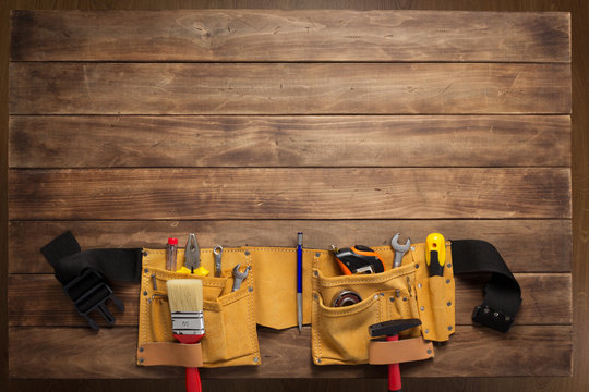 instruments in tool belt at wooden table