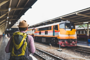 Young man standing at train station