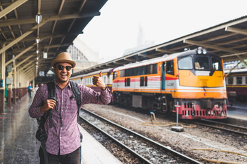 Young man standing at train station