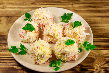 Appetizer of crab-cheese balls on wooden table