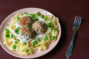 Pasta with meatballs on a dark background