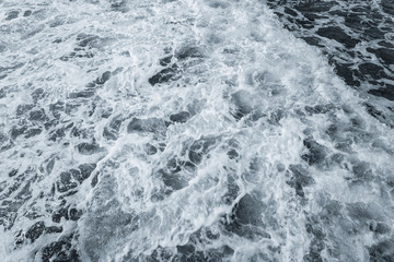 Fototapeta premium Beautiful splashing dark blue sea water with foamy white surface. Horizontal color photography of stormy Red sea.