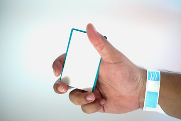 Hand with paper wristband and hold card payment