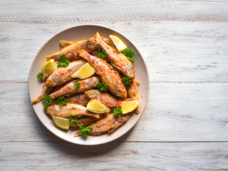 Dietary surmullet fish. Fried fish in a plate. 