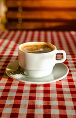 A Cup of cappuccino is on the table in the cafe 