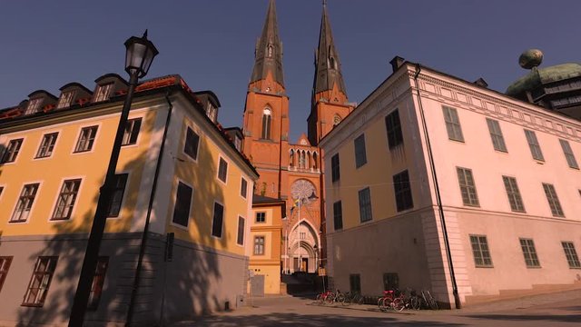 Beautiful view on cathedral church between old buildings on blue sky background. Europe.Sweden. Uppsala