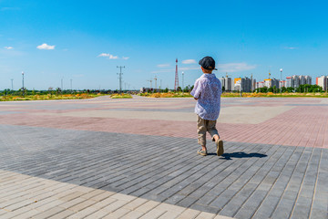 Little boy walking in the new Park