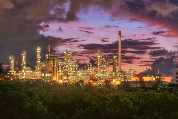 Oil​ refinery​ and​ petrochemical​ plant, refinery​ factory​ natural​ gas​ storage​ tank​ at​ yellow​ sky​ background​