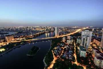 Obraz premium Aerial skyline view of Hanoi cityscape at twilight. Linh Dam peninsula, Hoang Mai district, Hanoi, Vietnam