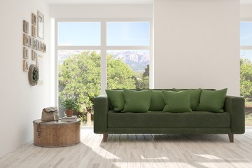 Obraz premium Stylish room in white color with sofa and summer landscape in window. Scandinavian interior design. 3D illustration