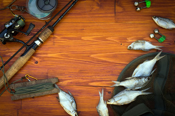 Fishing tackle-fishing spinning rods, hooks, floats and lures on wooden background