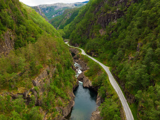 Fototapeta na wymiar Road and river in green mountains, Ryfylke Norway
