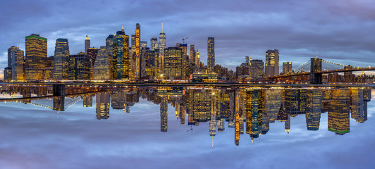 Panorama scene of New york Cityscape with Brooklyn Bridge beside the east river at the twilight time, Reflection with opposite concept, USA downtown skyline, Architecture and building with tourist