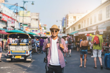 Young asian traveller man walking in Khaosan Road walking street in bangkok thailand on vacation...