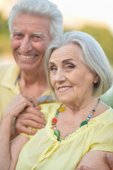 Beautiful senior couple hugging in the park