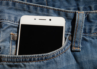 white phone in the pocket of a denim jacket