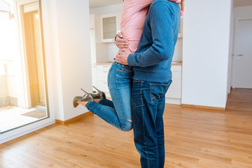 Woman hugging her man being happy in the new apartment