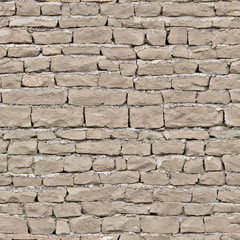 The cracked old wall of the house is made of brown brick.Texture or background