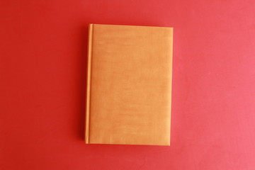 book with orange cover on colorful background