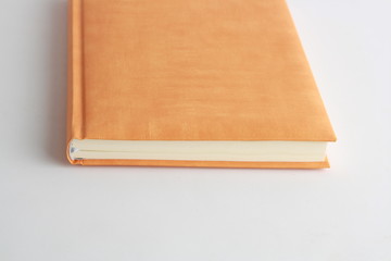 Fototapeta premium book with orange cover on colorful background