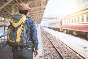 Young traveler man at platform train station. Traveling concept.