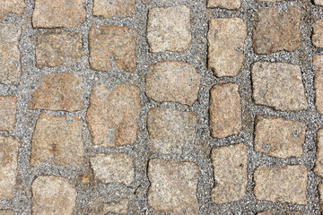 Fototapeta premium Old stone pavement texture. Granite cobblestones pavement background. Abstract background of old cobblestone