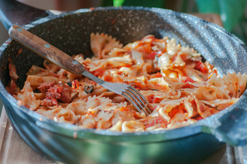 Italian pasta, butterflies on the table with olives and vegetables	