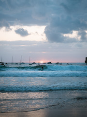 Surfer enjoying the sunset riding a wave in San Sebastian