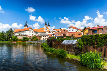 Fototapeta premium View of Telc across pond with reflections, Unesco world heritage site, South Moravia, Czech Republic.