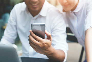 Business man and woman using  smartphone. Working concept.