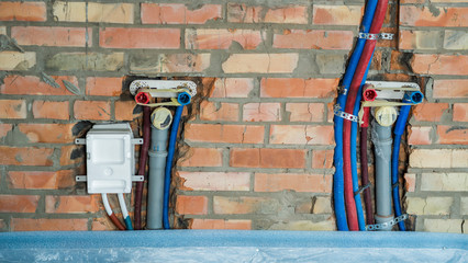 Pipes for hot and cold water and sewage pipes mounted in the wall