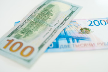 American 100 dollar banknote and 2000 russian roubles. Concept trade, cooperation or wrestling.