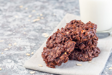 Flourless no bake peanut butter and oatmeal chocolate cookies  with glass of milk, horizontal, copy...