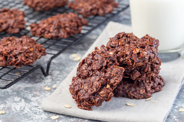 Flourless no bake peanut butter and oatmeal chocolate cookies  with glass of milk, horizontal