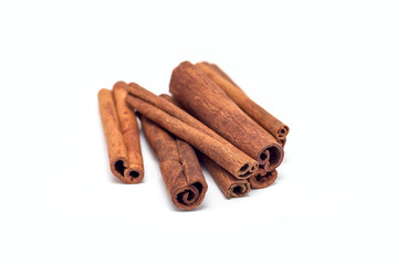 Heap of cinnamon sticks isolated on a white
