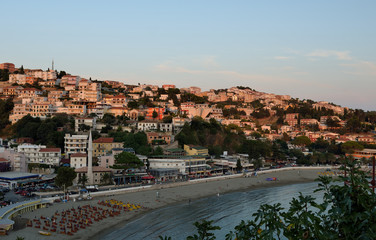 Obraz premium Panoramic view on coast on the old town of Ulcinj with the Kalaja castle neighboring with the central beach, Montenegro at sunset.