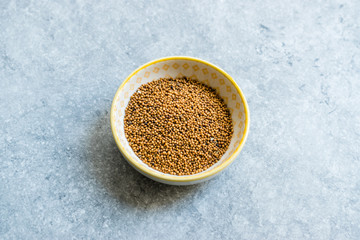 Yellow Mustard Seeds in Small Porcelain Bowl.