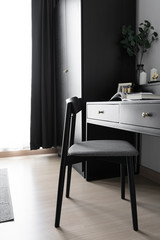 Dressing table corner with black wood power table and black wooden chair  decoration in natural light scene / cozy interior concept / black interior scandinavian style /interior design