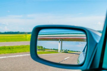 Fototapeta na wymiar View of the road in the rear view mirror