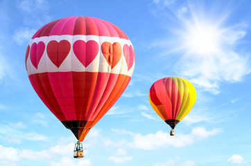 Colorful hot air balloon over bright sky with clouds. Hot air balloon and blue sky background.