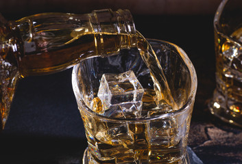 Pouring Whiskey into a Glass With Ice