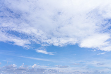 The sky is bright blue. There are clouds floating through. Feel relax when looking. See the sun on the sun.