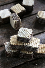 Filled wafer cubes Milk chocolate cream on a wooden table in the morning light