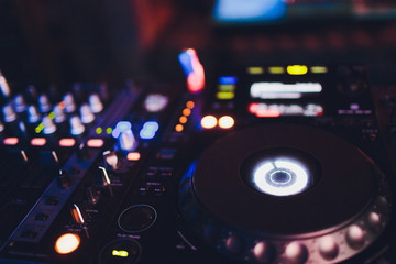 Fototapeta na wymiar Night club, nightlife concept. Disco. DJ hands mixing the DJ controller.